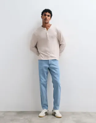 stretch tapered jeans in light stone wash blue