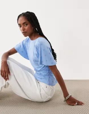 cinch waist angel sleeve tee with v back detail in pastel blue polka dot print